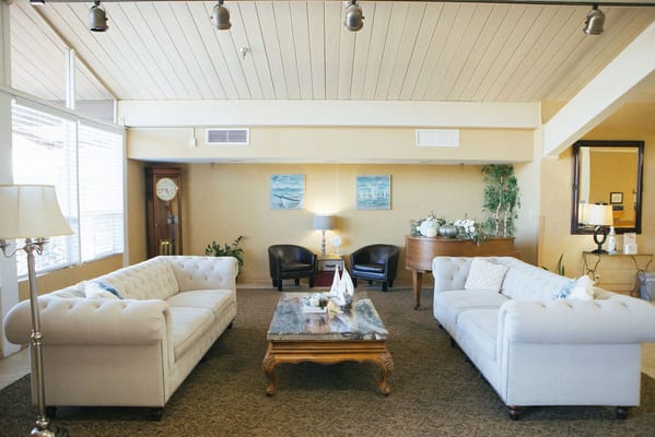 Inviting lounge with two sofas, a coffee table, and piano