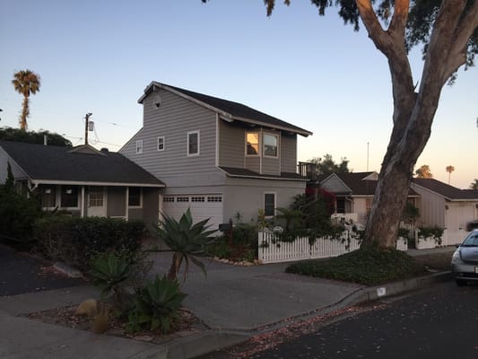 Exterior of a senior living facility with landscaping and palm trees.