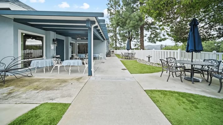 Outdoor seating area with tables and chairs