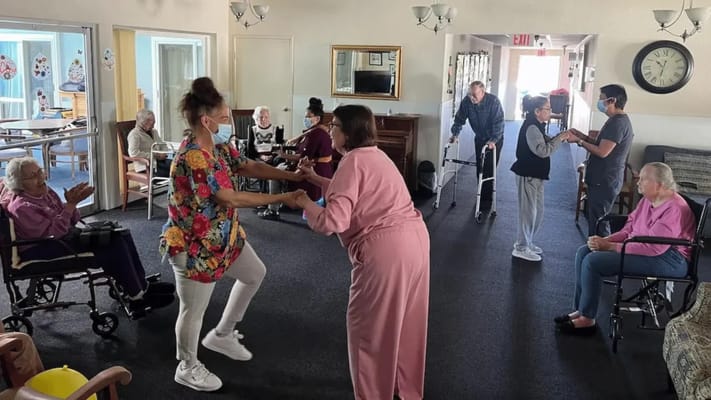 Residents and staff engaging in an activity in the common area