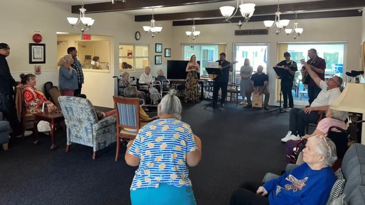 Residents enjoying a live music performance in a common area