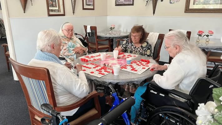 Residents playing bingo at a round table