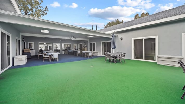 Outdoor space with green lawn and seating area