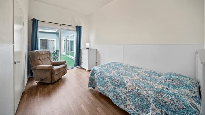 Private resident room with a comfortable chair and bed