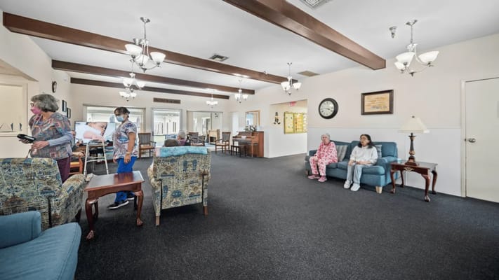 Residents and staff interacting in a cozy common area