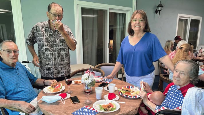 Residents enjoying a meal outdoors comfortably