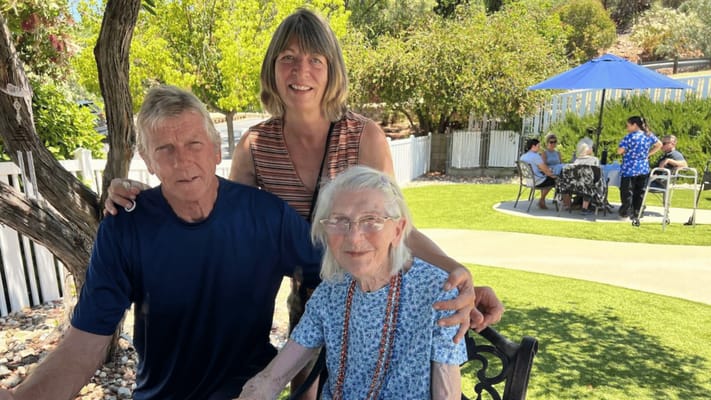 Residents with staff in an outdoor garden area
