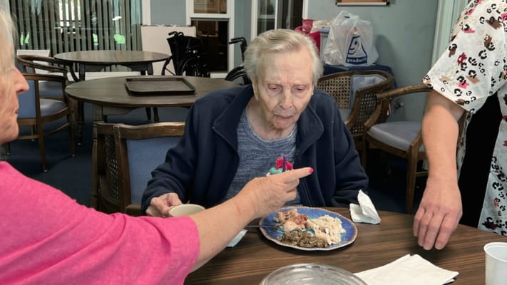 Residents enjoying a meal together at a dining table