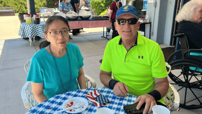 Residents enjoying outdoor dining with festive decor