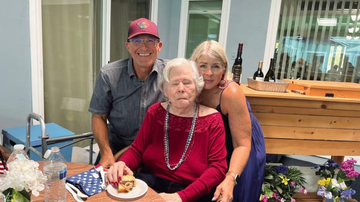 Residents celebrating with cake in a common area