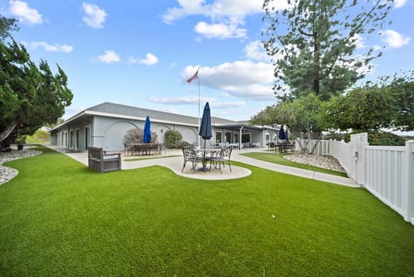 Outdoor patio area with seating and greenery