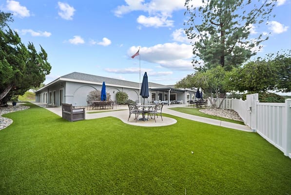 Outdoor patio area with seating and greenery