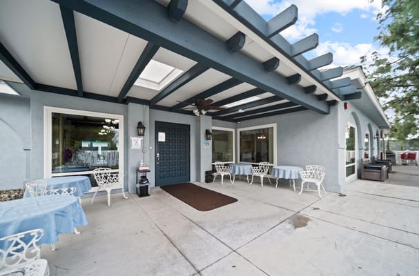 Entrance of a senior living facility with outdoor seating