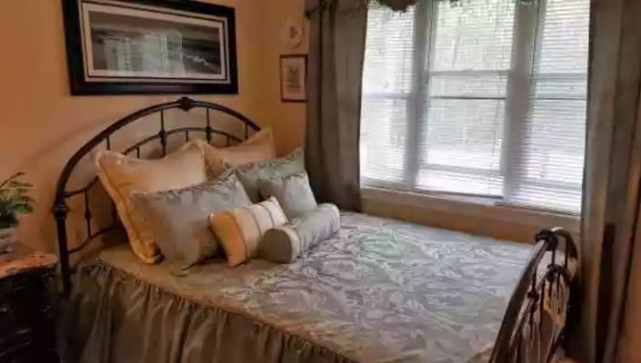 Cozy bedroom with a bed and window overlooking nature