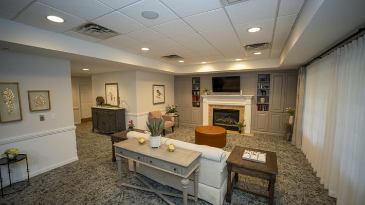 A cozy common area with seating and a fireplace