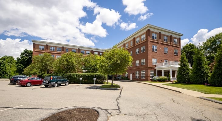 Exterior view of Wingate Residences building with parking area