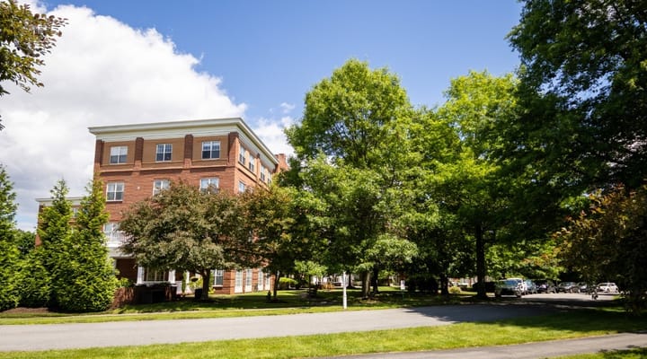 Exterior view of Wingate Residences with trees and blue sky