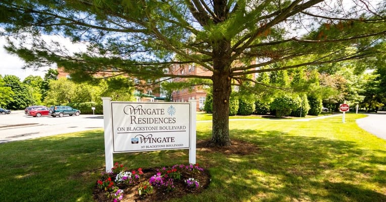 Sign of Wingate Residences on Blackstone Boulevard in a garden setting