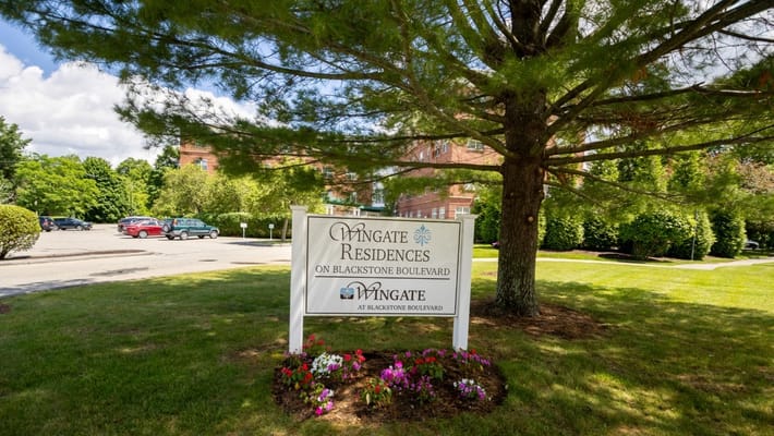 Sign for Wingate Residences surrounded by greenery