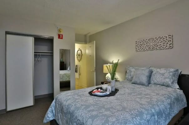 Cozy resident room with a bed and a tray of food