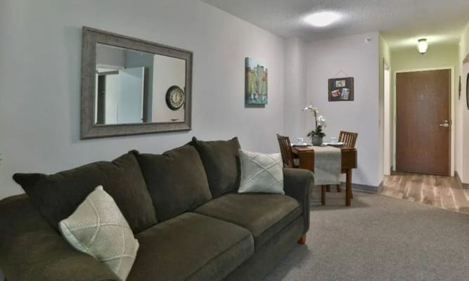 Cozy resident room with a sofa and dining table