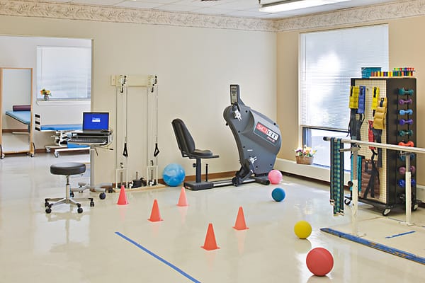 Interior view of the therapy room with exercise equipment and therapy tools