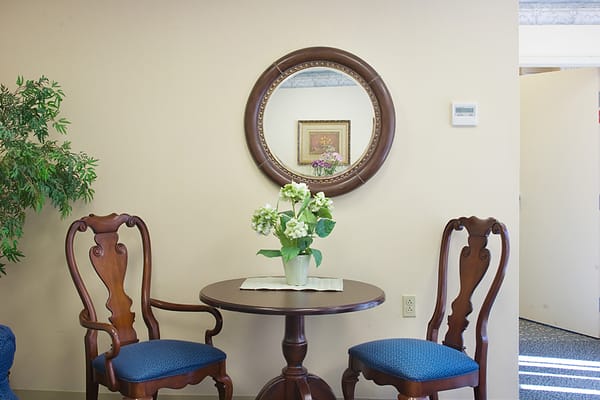 Elegant table and chairs with a floral arrangement in a living area