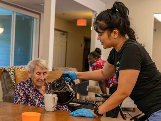 Staff member serving coffee to a resident