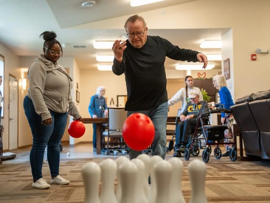 Residents engaging in an indoor bowling activity