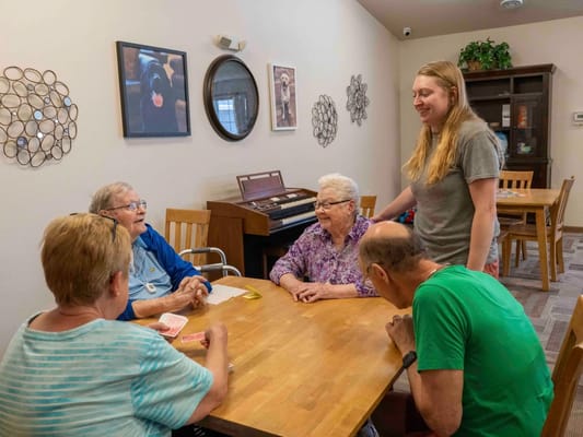 Residents engaged in conversation at a common area table