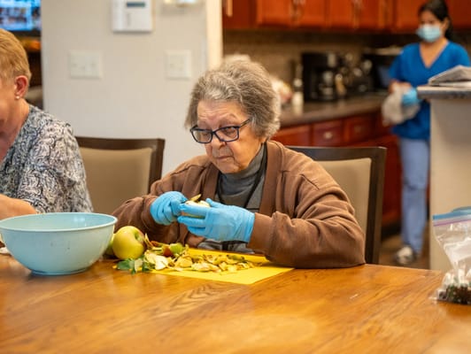 Resident preparing food at the kitchen table