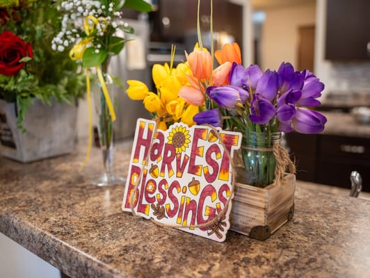 Colorful flower arrangement with a decorative sign