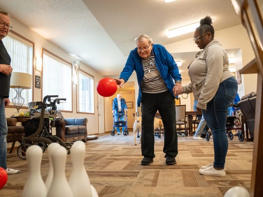 Residents engaged in a bowling activity in the common area
