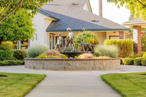 Outdoor sculpture featuring children and a dog