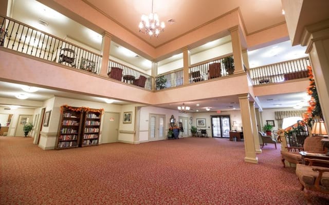 Bright common area with comfortable seating and bookshelves