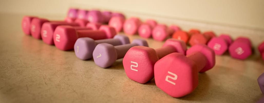 Colorful dumbbells arranged on a table
