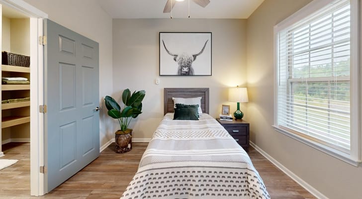 Cozy interior of a resident room with a bed and decor