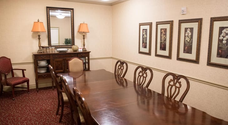 Dining room with a large wooden table and wall decorations