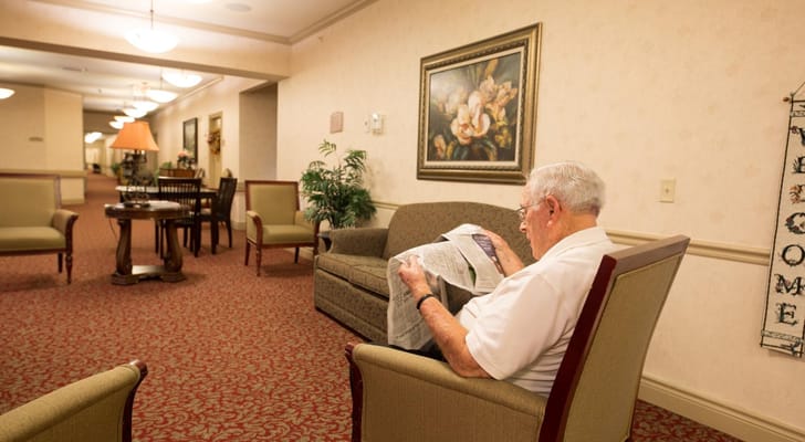 Resident reading in a cozy common area