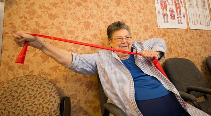 Resident engaged in an exercise activity with a resistance band