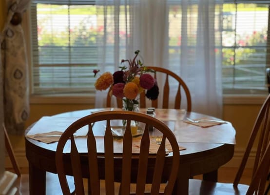 Bright dining area with a flower centerpiece
