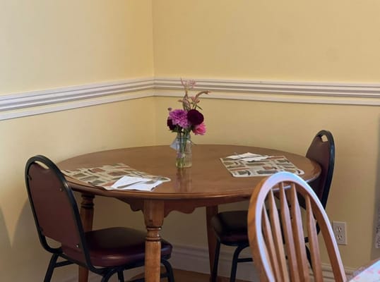 Small dining table decorated with flowers