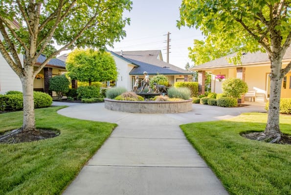 Pathway through landscaped courtyard with a fountain