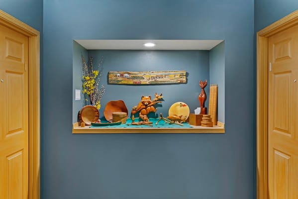 Wooden decor and art displayed in a wall niche