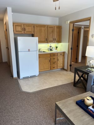 Spacious kitchen with wooden cabinets and refrigerator