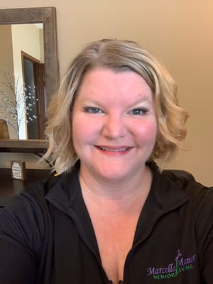 Staff member smiling in the facility's common area