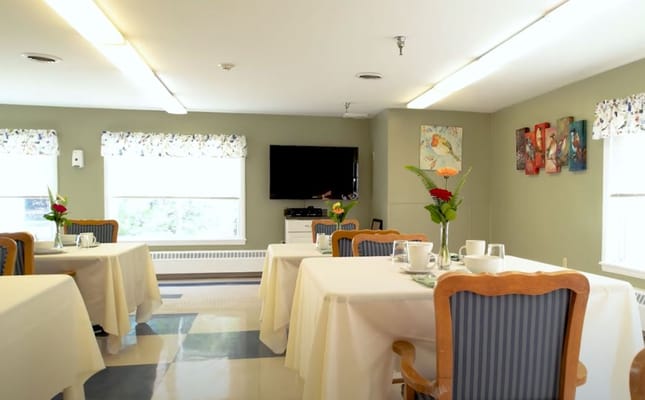 Bright dining area with table settings and decor