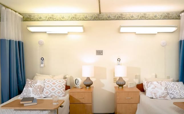 Brightly lit shared bedroom in assisted living facility