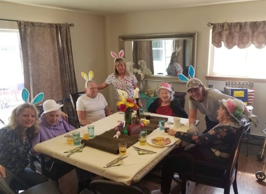 Residents and staff celebrating with festive hats