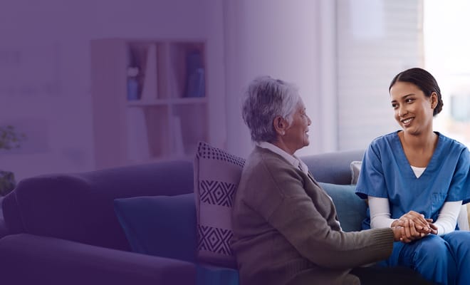 Caregiver engaging with a resident in a cozy living area